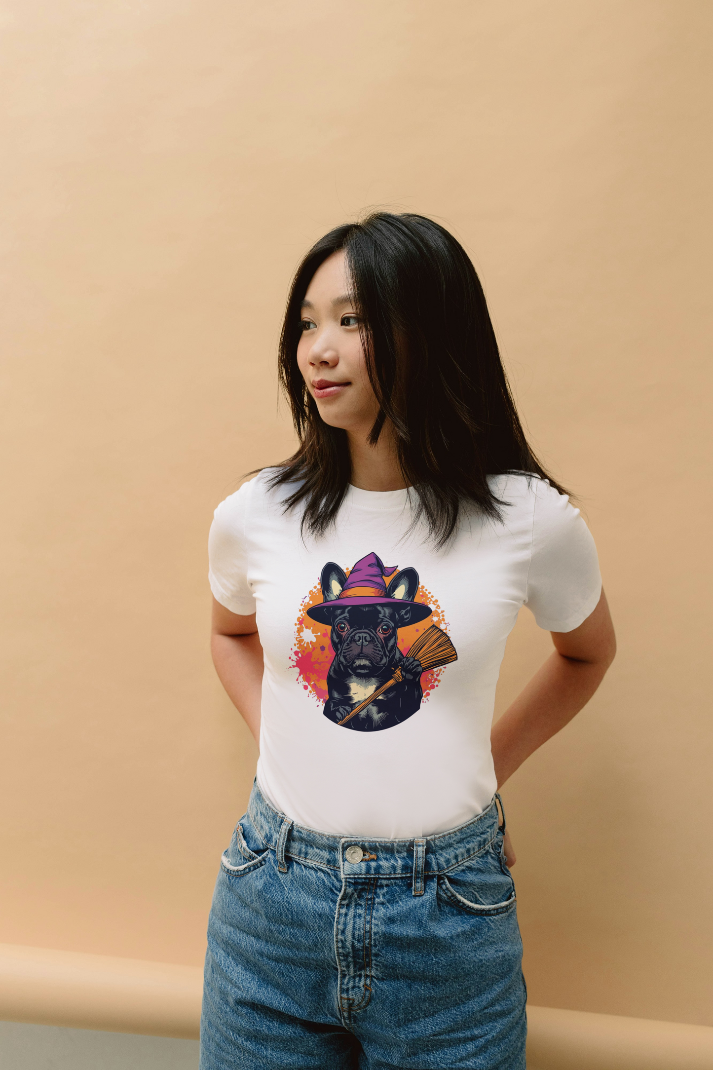Person wearing a white t-shirt with a colorful bear graphic on a beige background