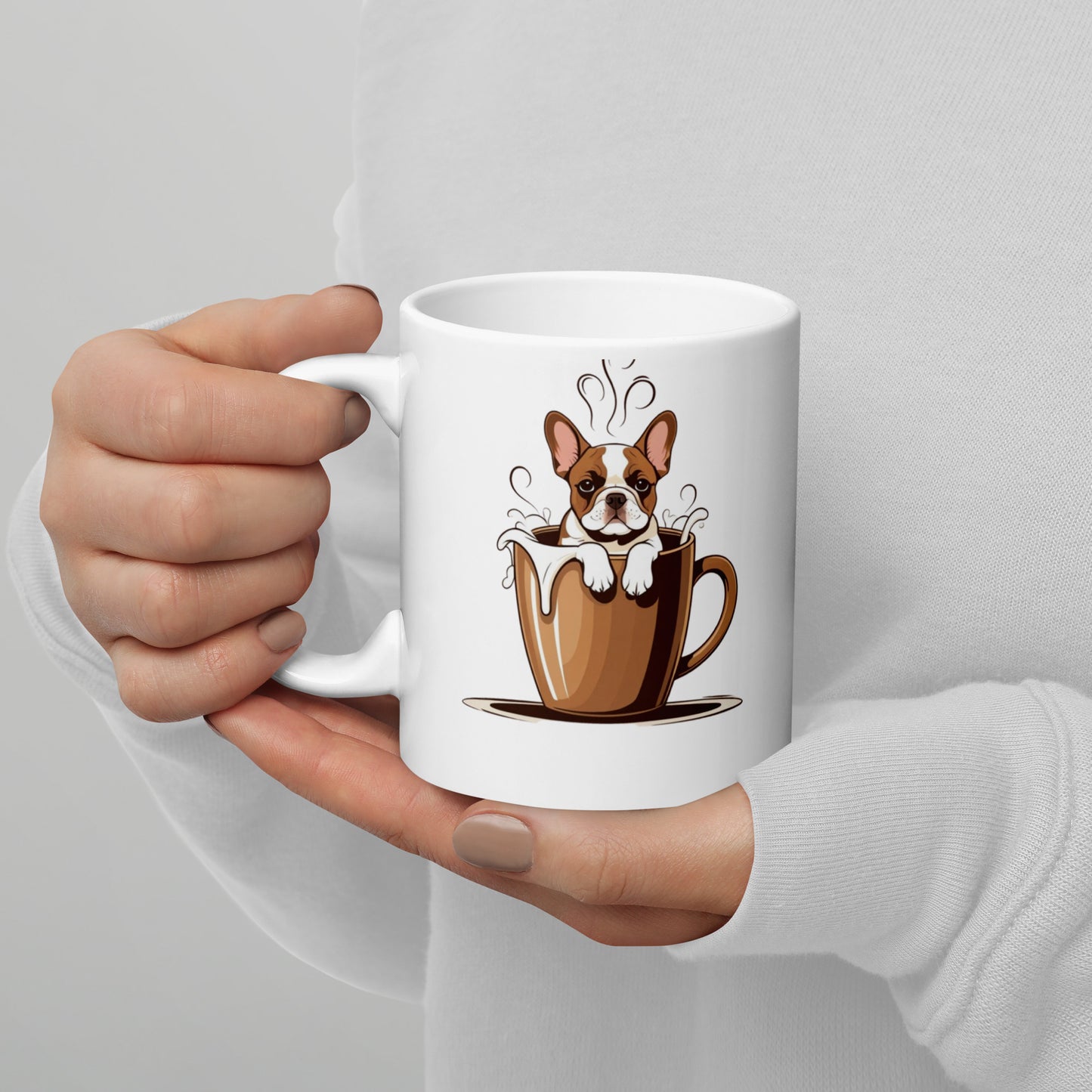 White mug with a cartoon dog in a coffee cup design held by a hand against a light gray background