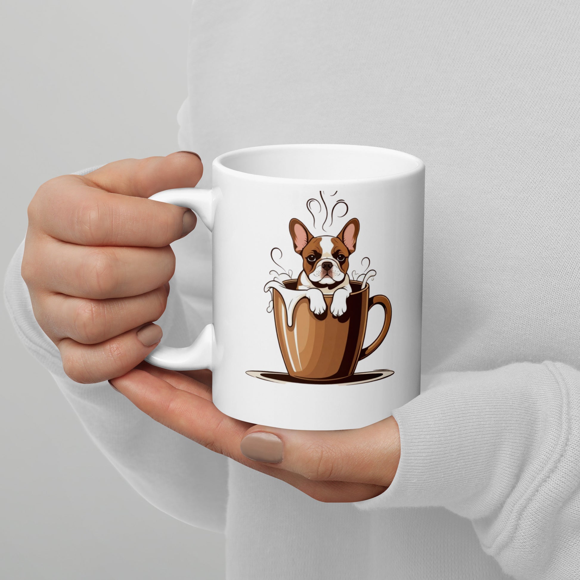 White mug with a cartoon dog in a coffee cup design held by a hand against a light gray background